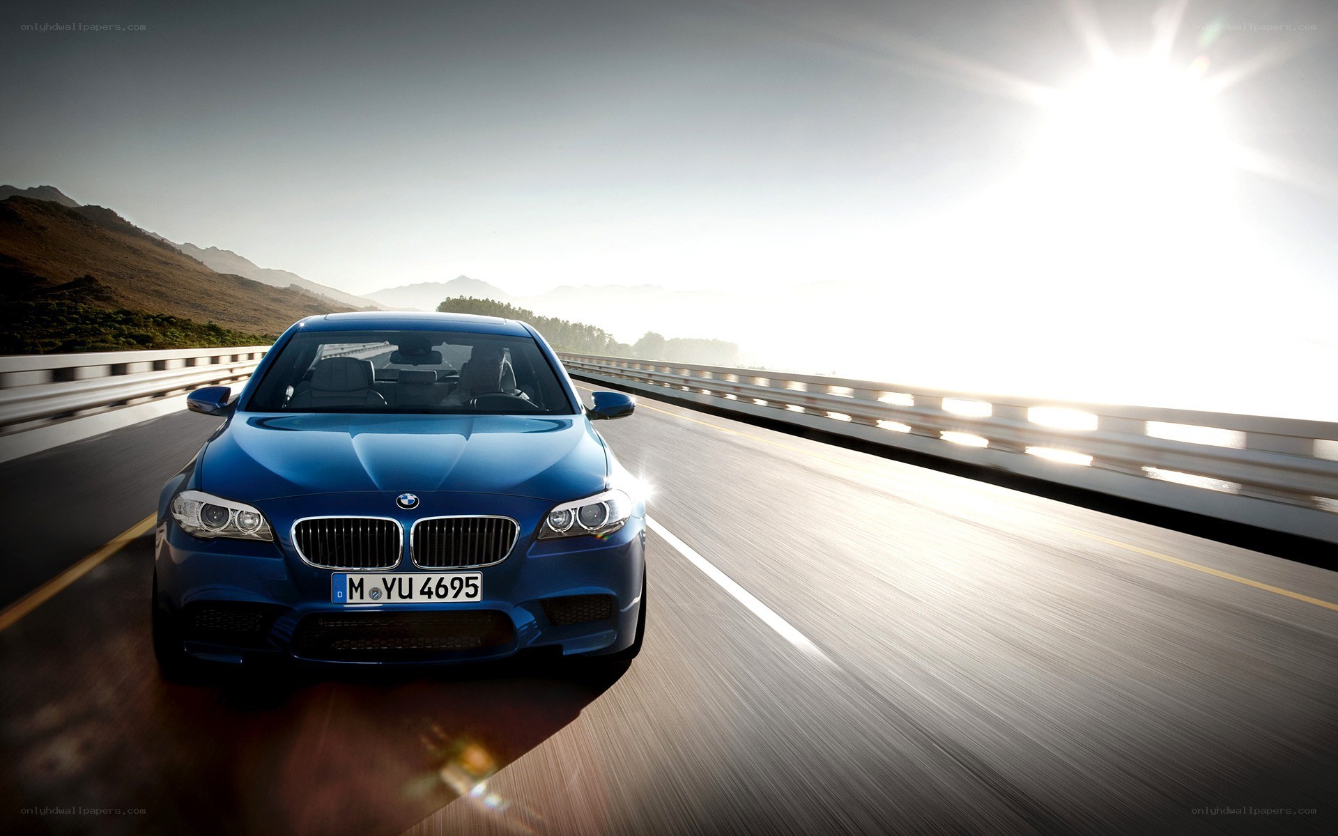 Blue BMW on a mountain road