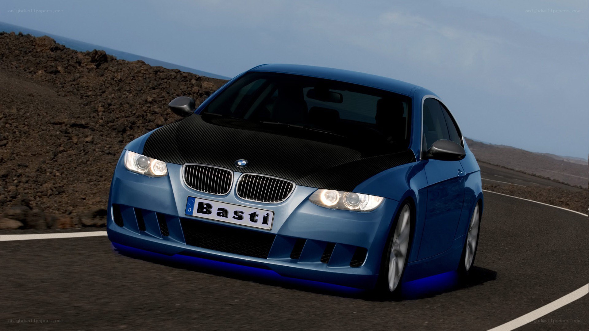 blue bmw on coastal road