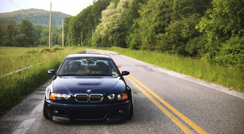 blue bmw on country road