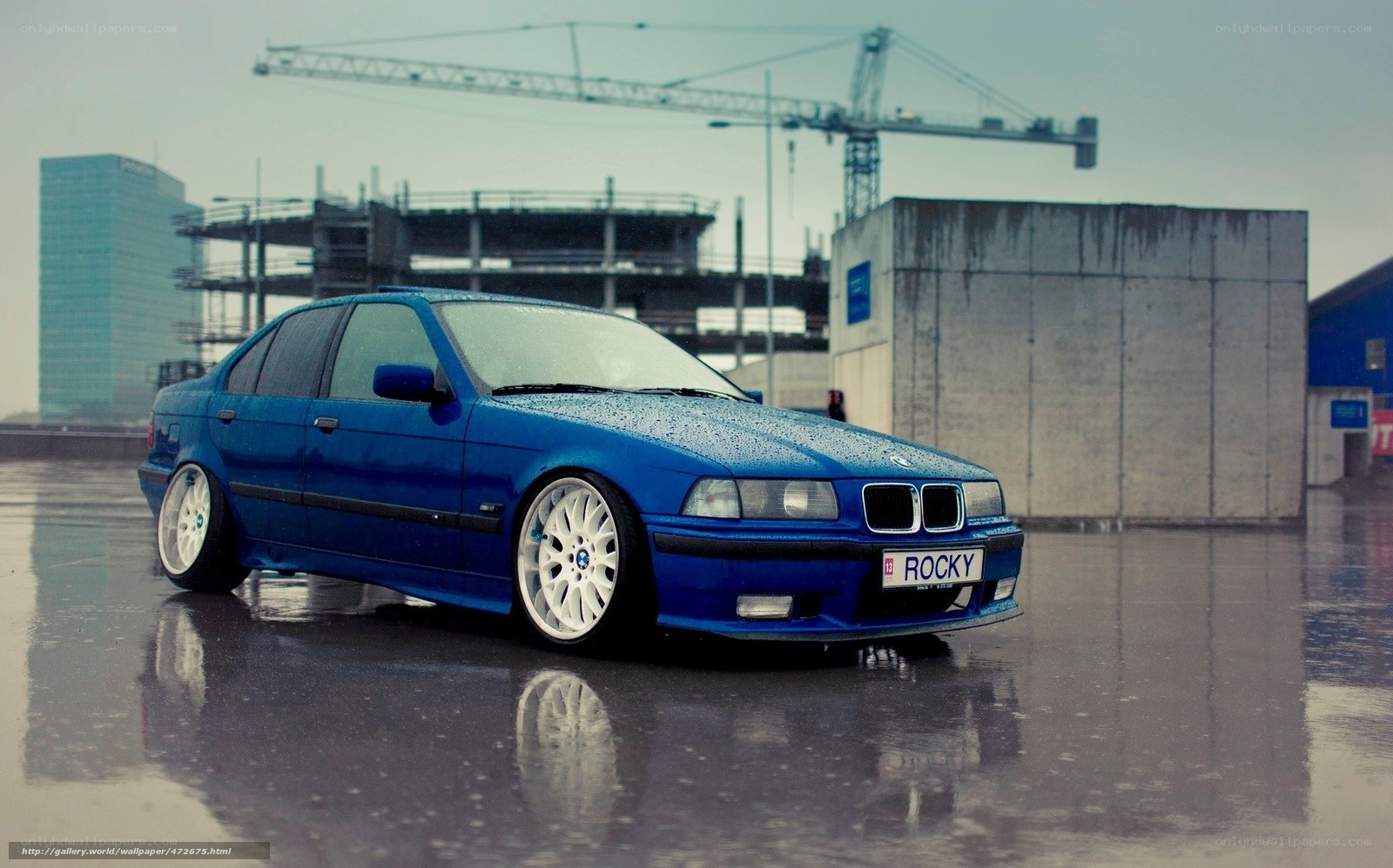 blue bmw on wet pavement