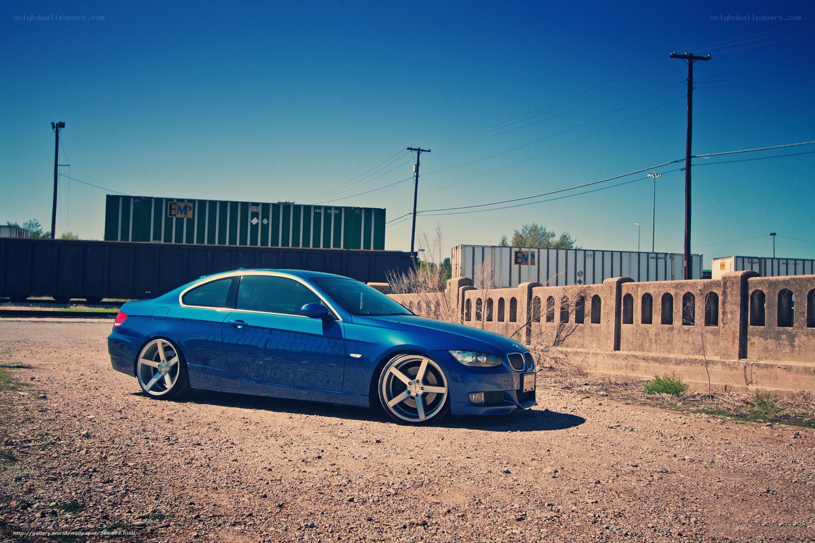 Blue BMW parked near train yard