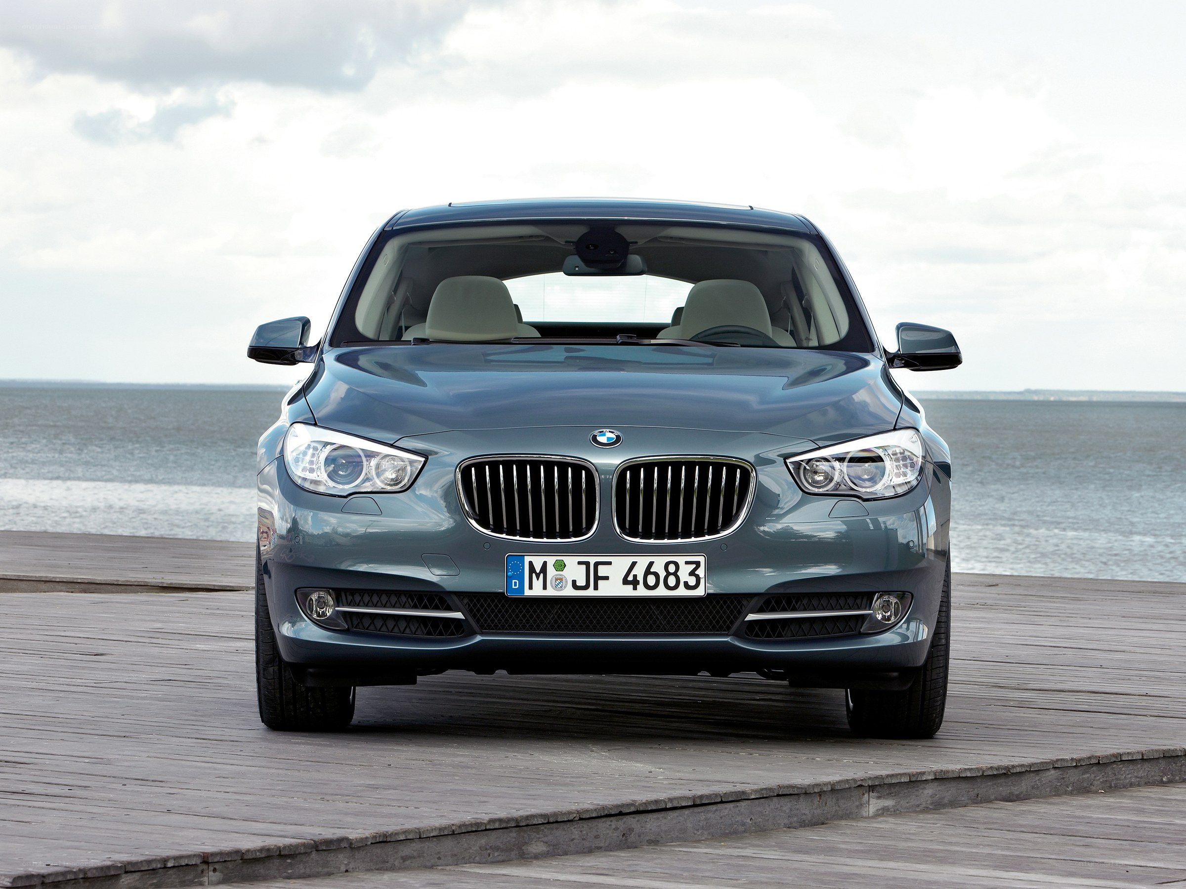 Blue BMW parked on a pier