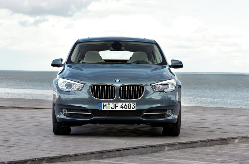Blue BMW parked on a pier