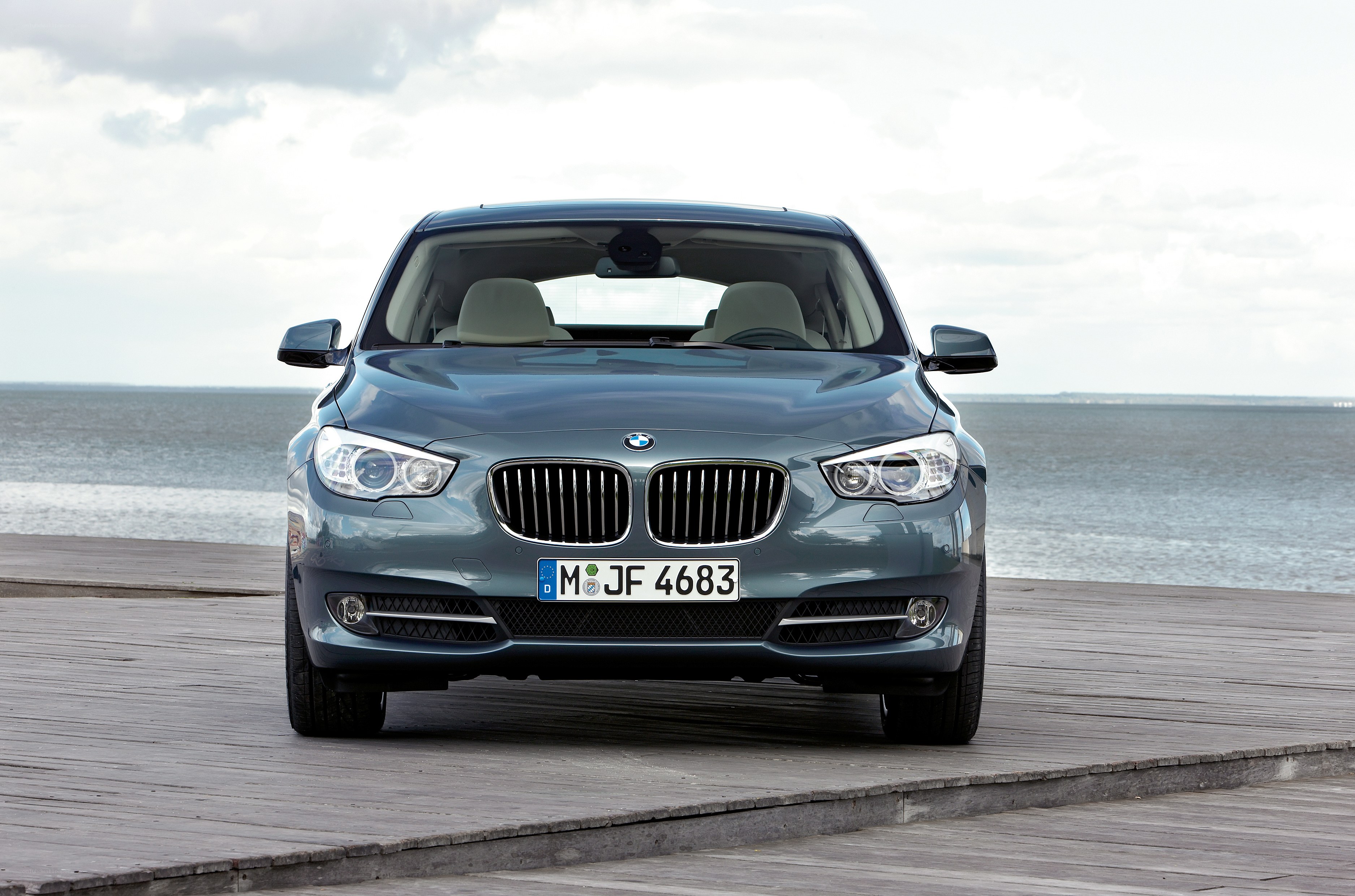 Blue BMW parked on a pier