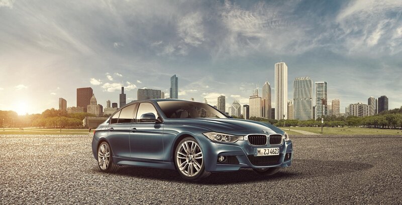Blue BMW sedan in cityscape
