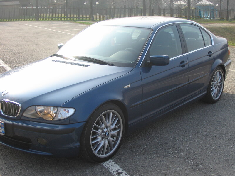 blue bmw sedan in parking lot