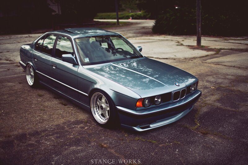Blue BMW sedan on pavement