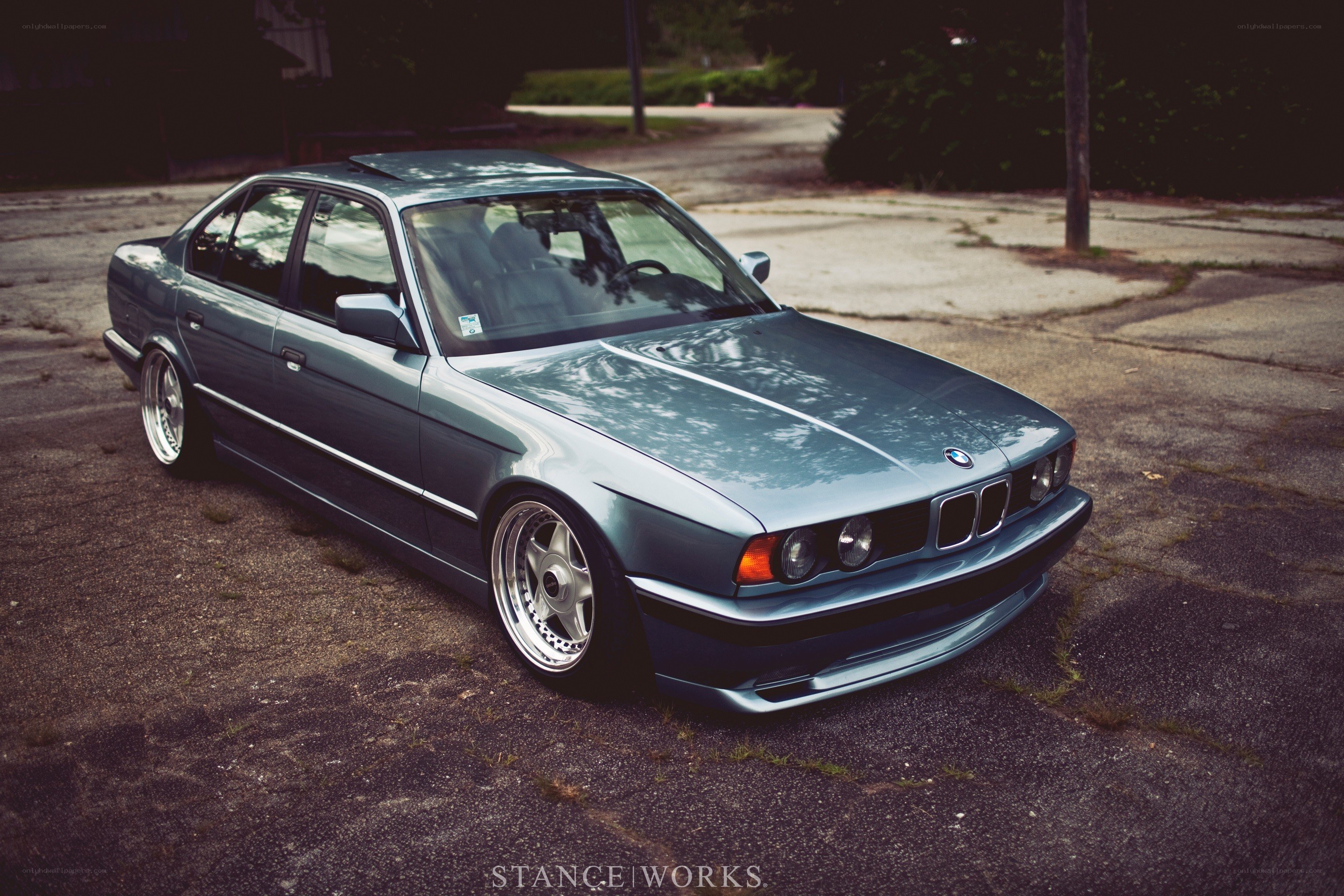 Blue BMW sedan on pavement