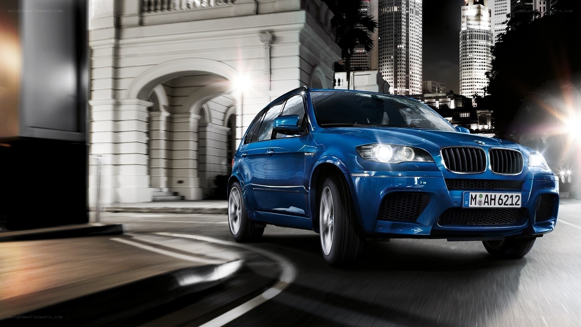 Blue BMW SUV at night