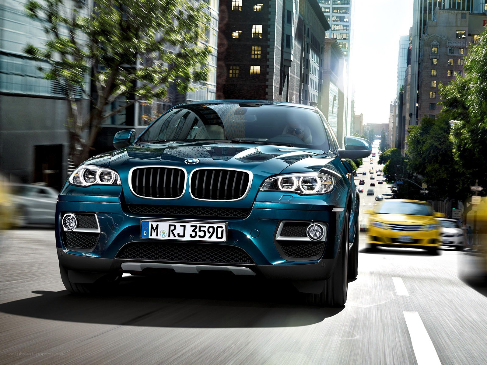 Blue BMW SUV in city traffic