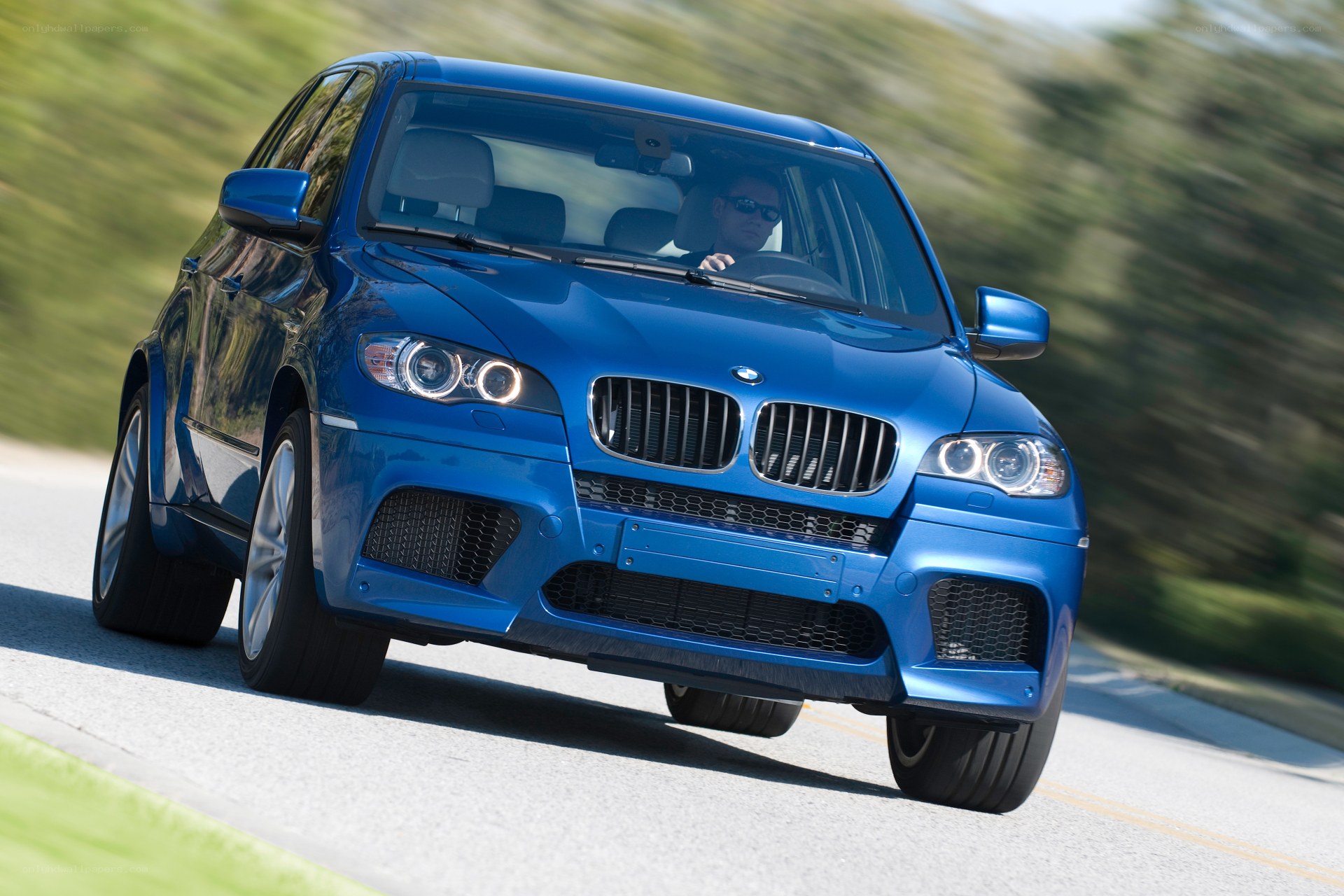 Blue BMW SUV in motion