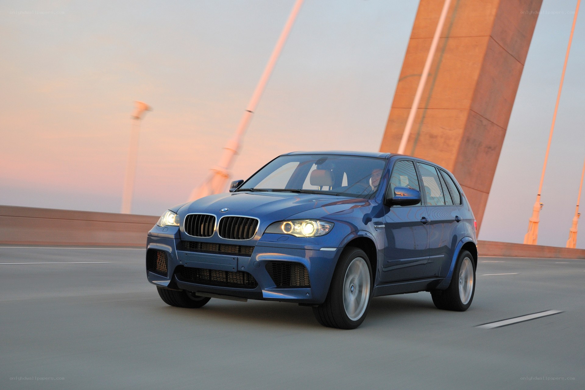 Blue BMW SUV on a bridge