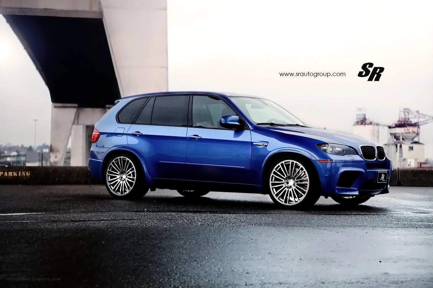 blue bmw suv on wet pavement