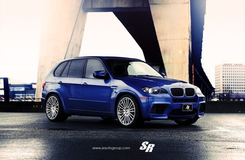 blue bmw suv under bridge