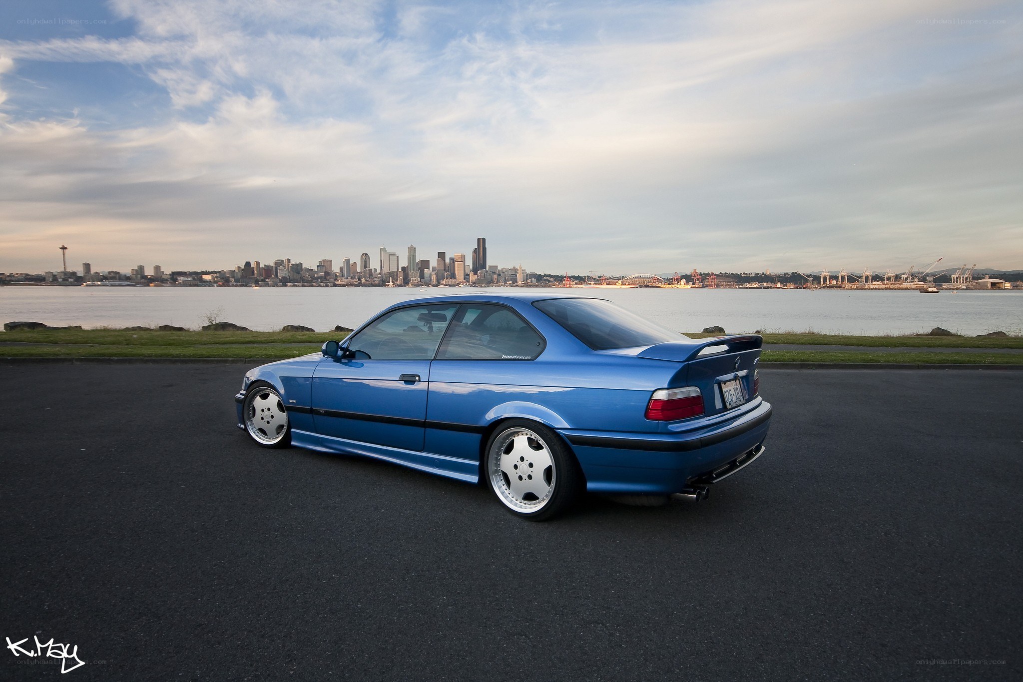 Blue BMW with city skyline
