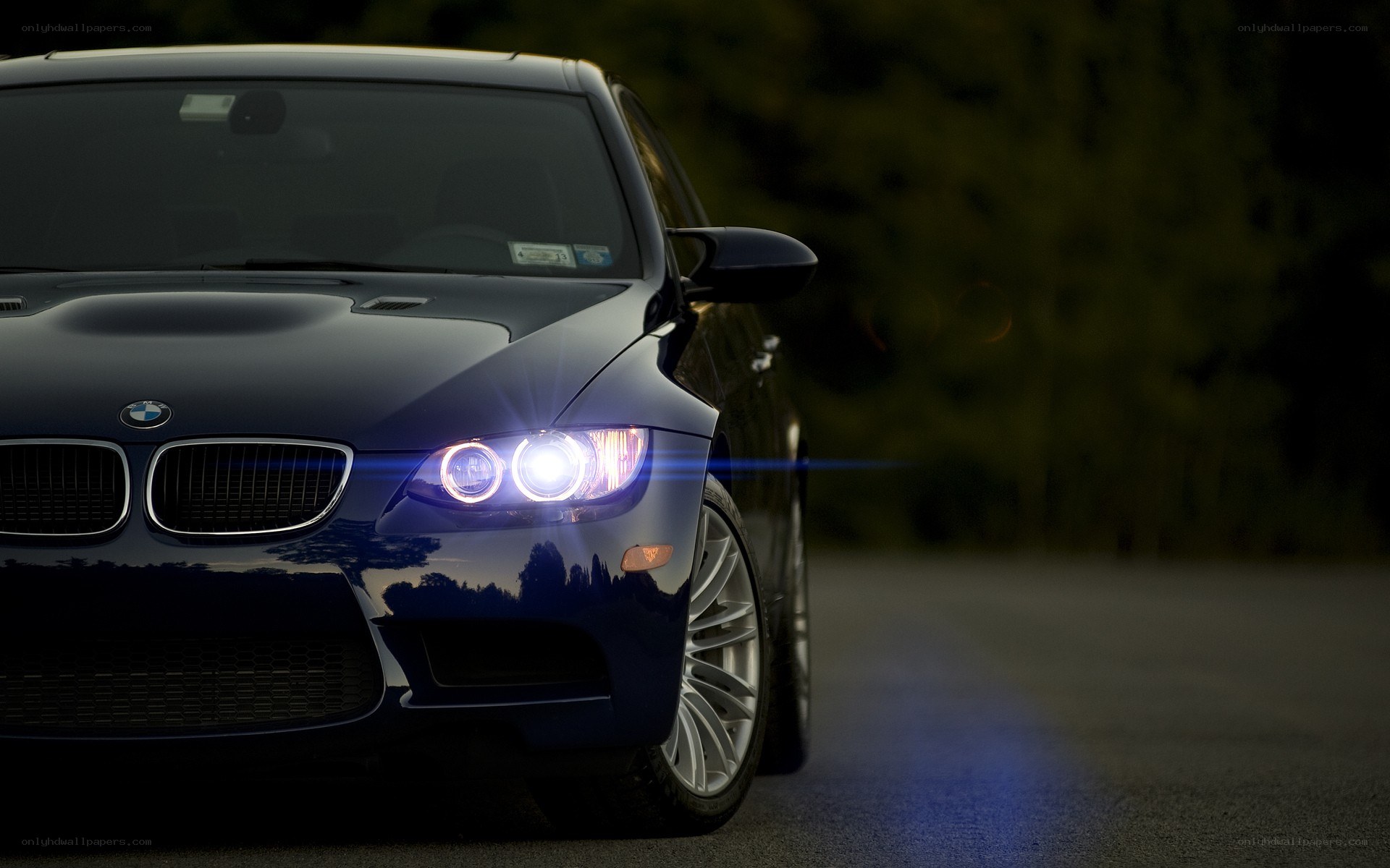 blue bmw with headlights on