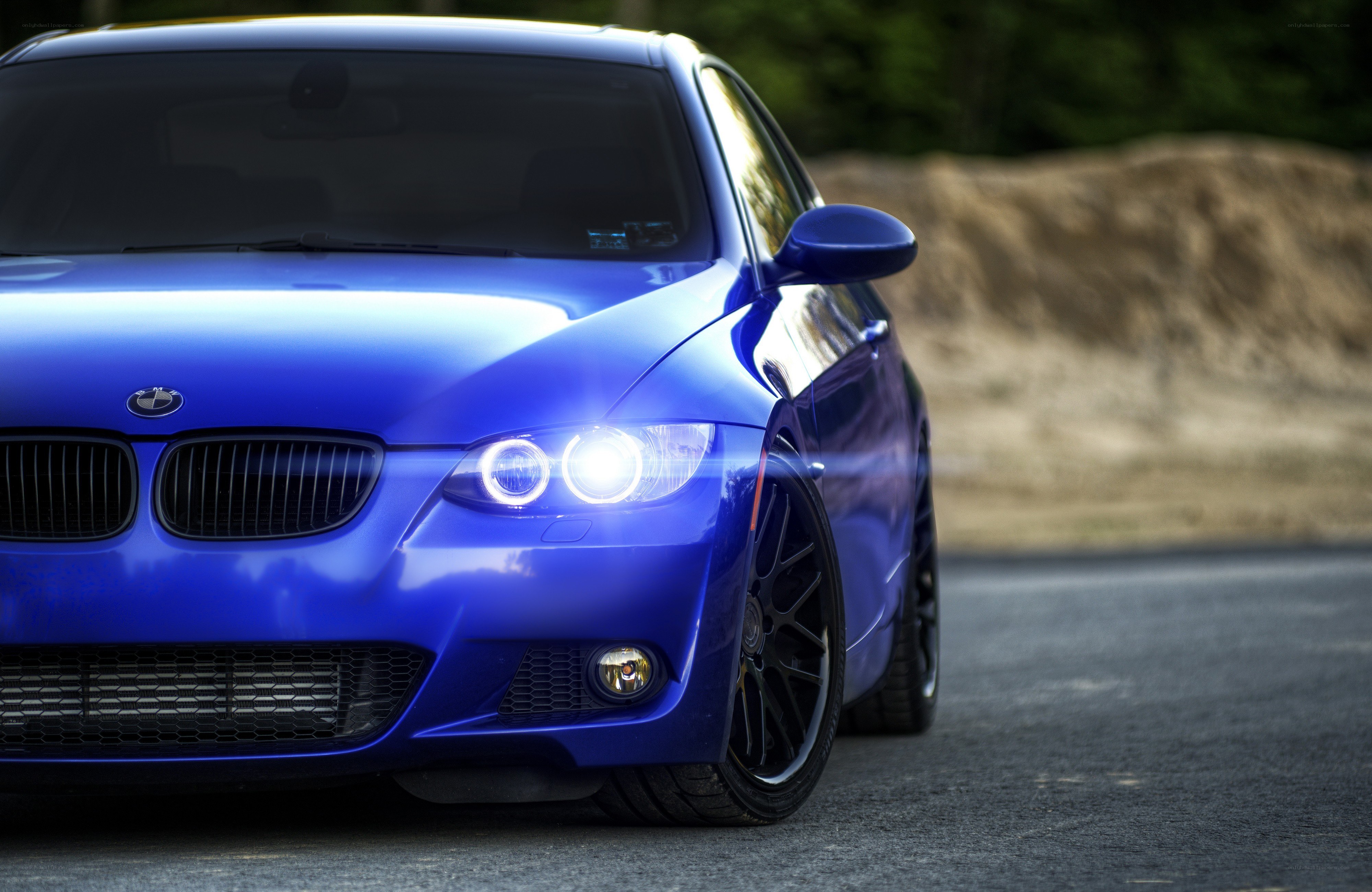 blue bmw with headlights on