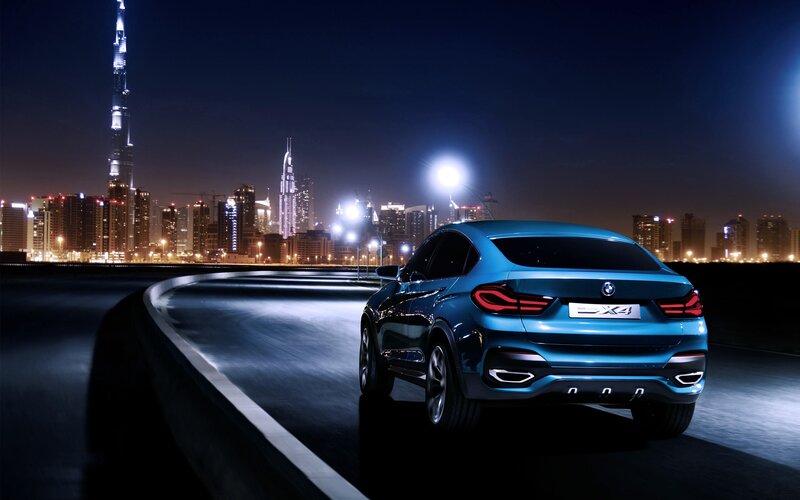 Blue BMW X4 at night in Dubai