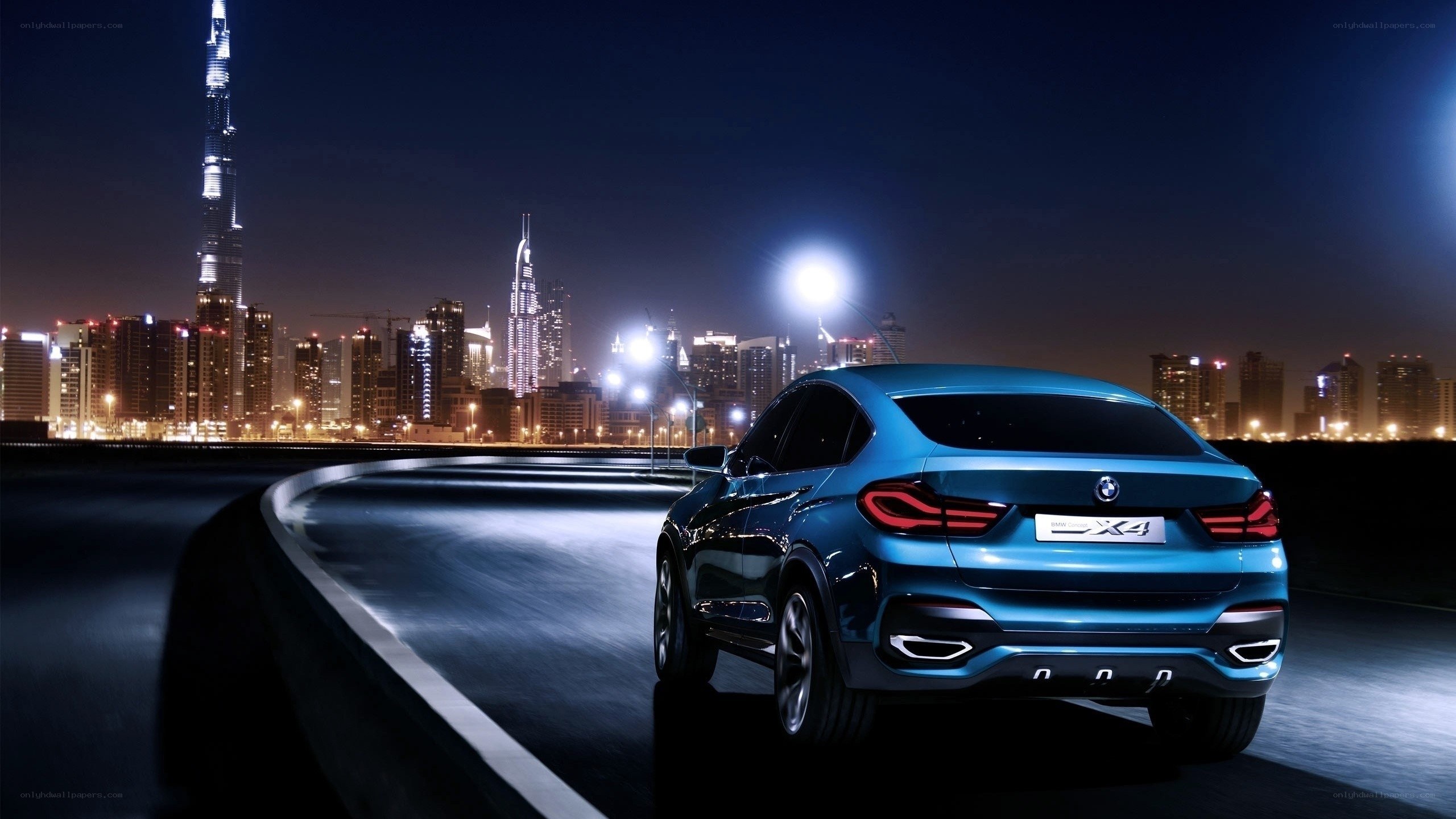Blue BMW X4 at night in Dubai