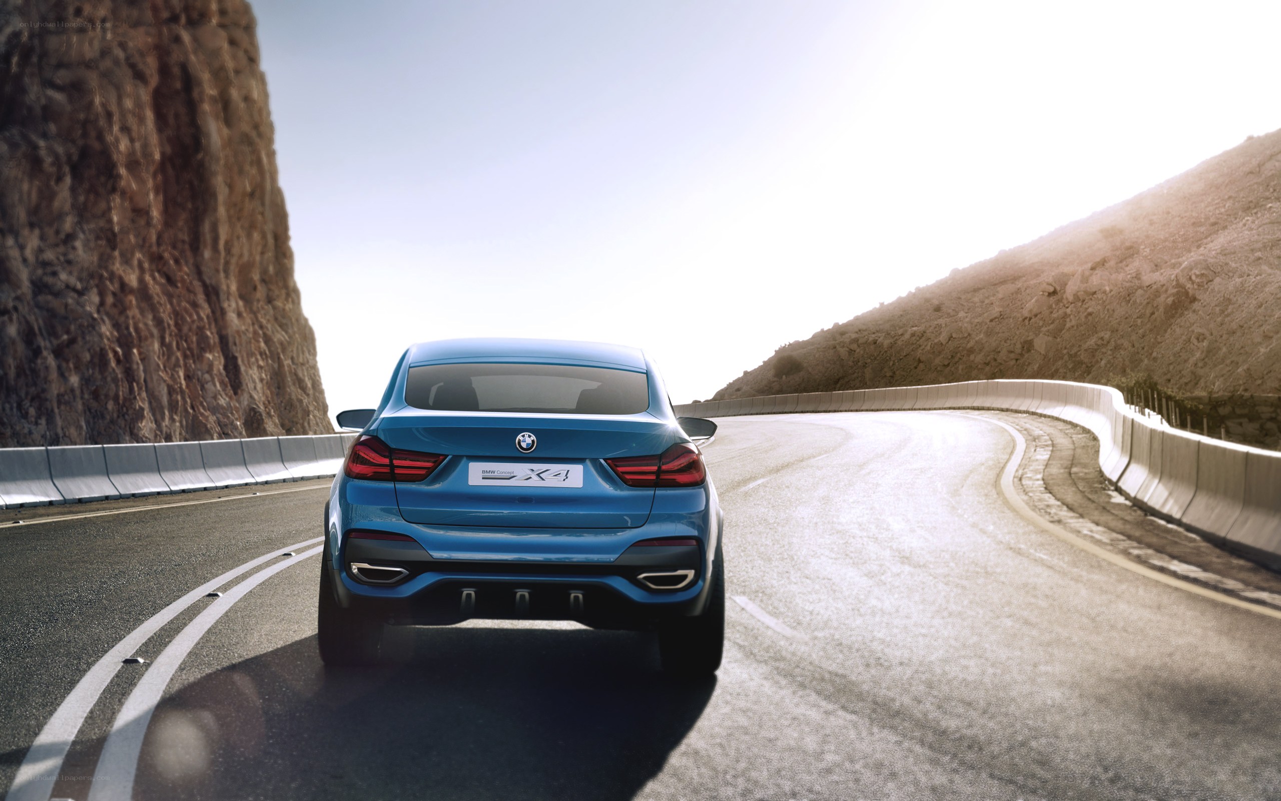 Blue BMW X4 on winding road