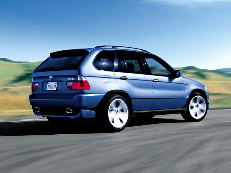 Blue BMW X5 driving on road