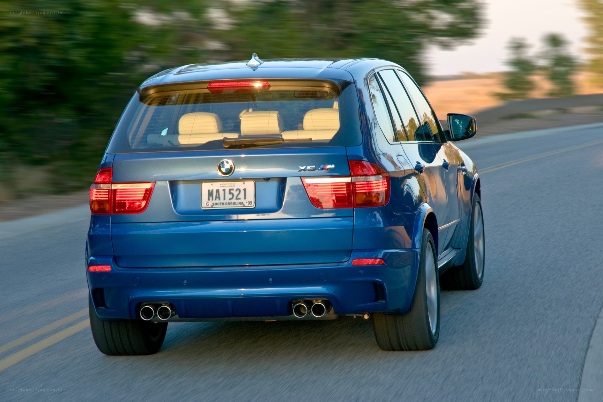 blue bmw x5 m driving