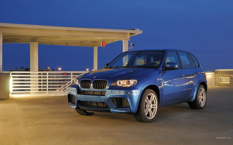 Blue BMW X5 M parked at night