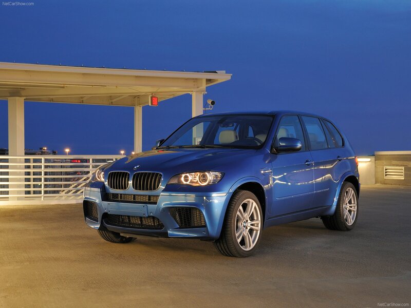Blue BMW X5 M parked at night