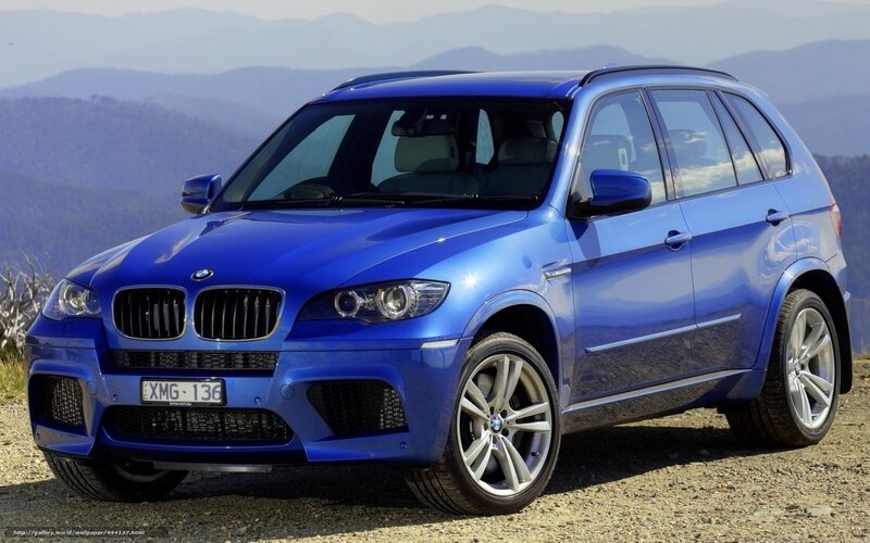 Blue BMW X5 M parked on a hill