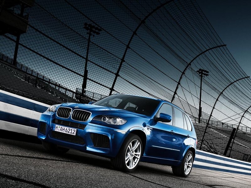 Blue BMW X5 on a racetrack