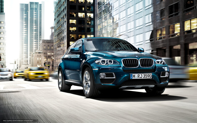Blue BMW X6 in city traffic