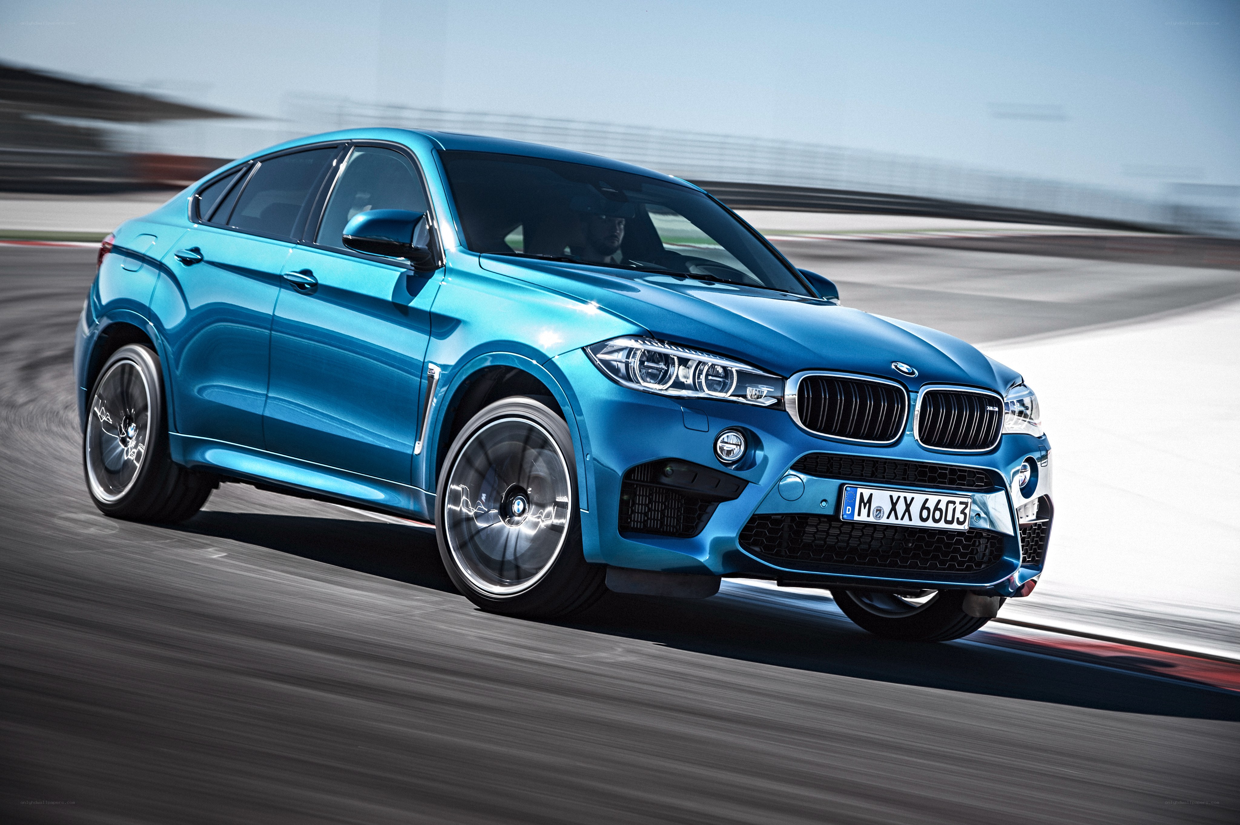 Blue BMW X6 M on racetrack