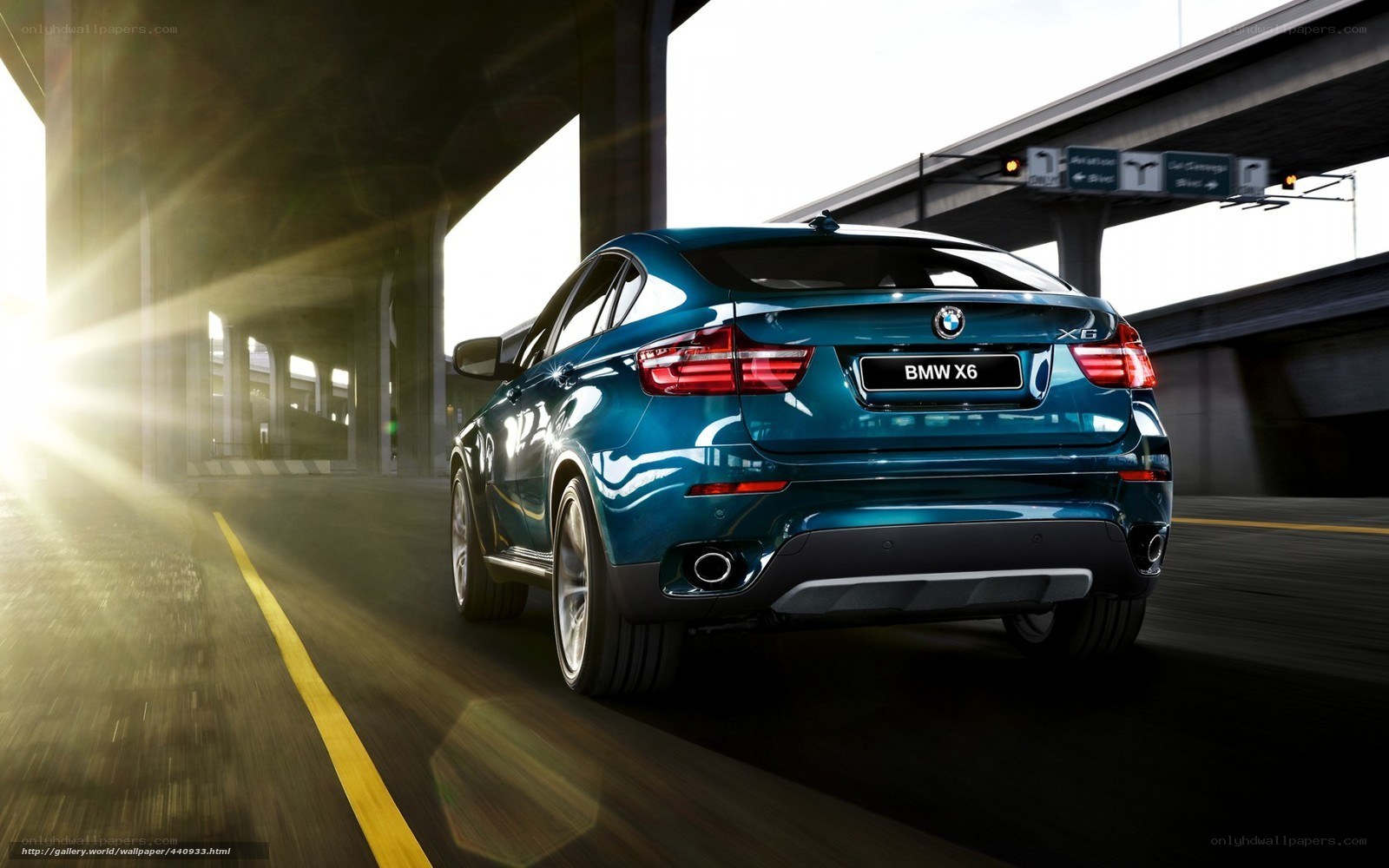 Blue BMW X6 on a highway
