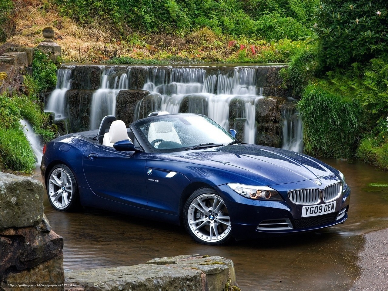 Blue BMW Z4 by a waterfall