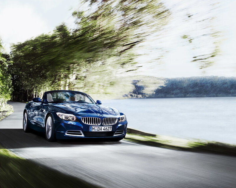 Blue BMW Z4 driving on a scenic road