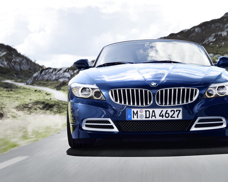 Blue BMW Z4 driving on mountain road