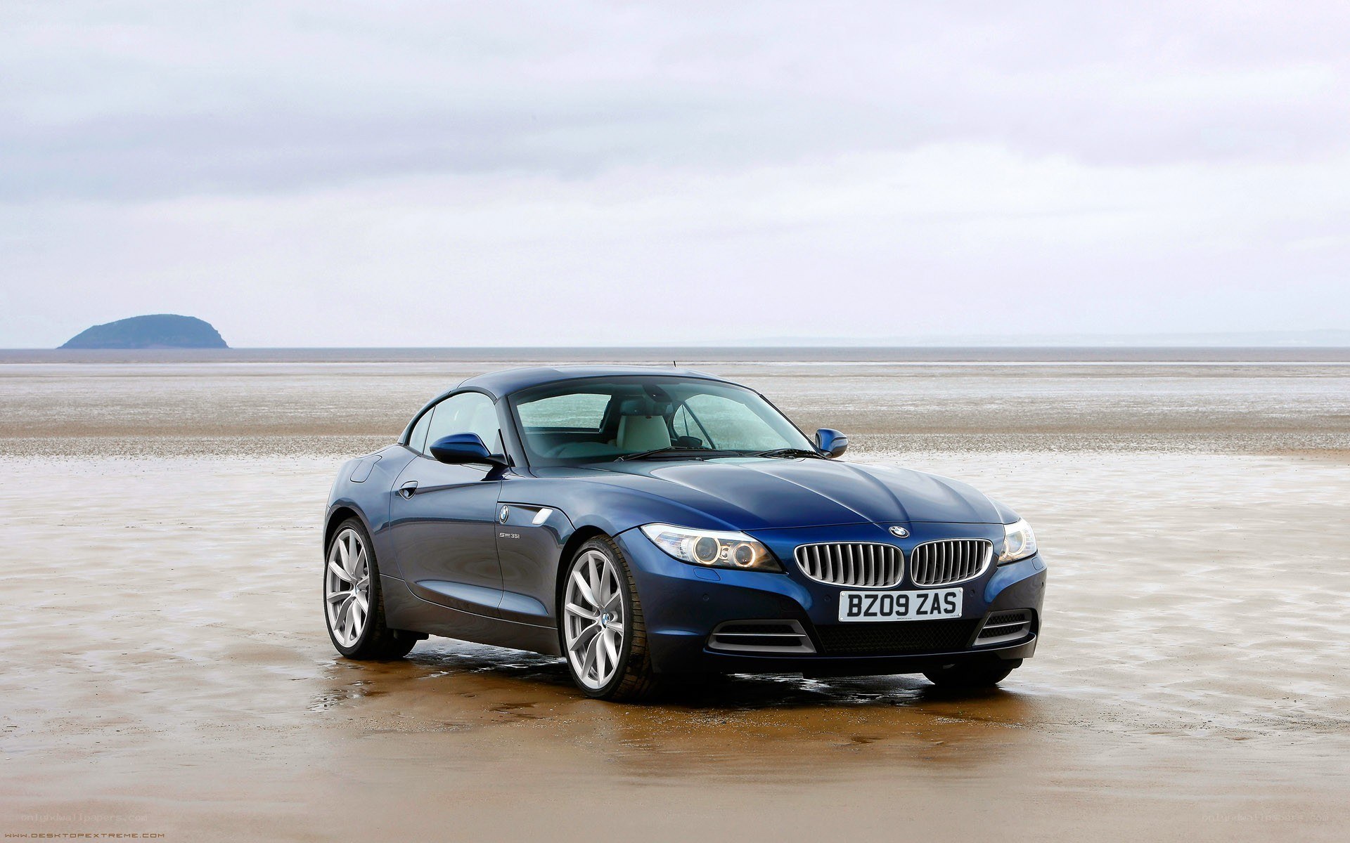 Blue BMW Z4 on a beach