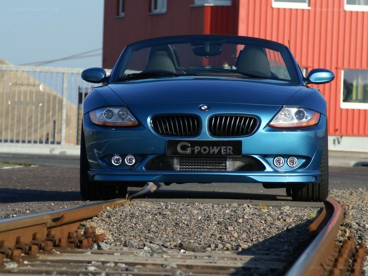 Blue BMW Z4 on train tracks