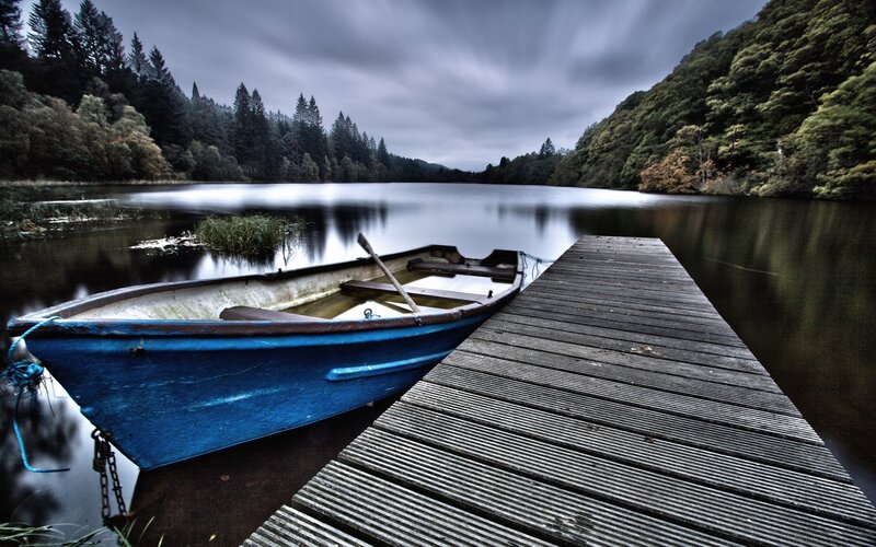Blue boat at a wooden dock