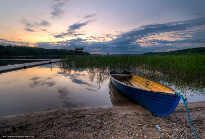 Blue boat at sunset on a lake