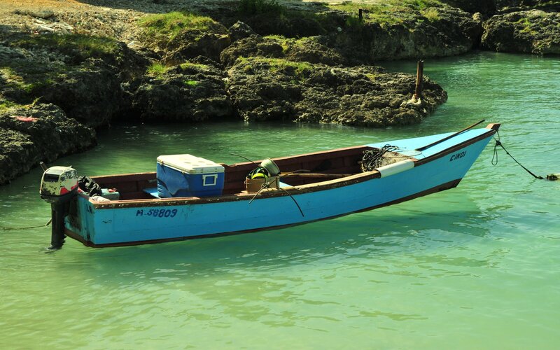 Blue boat in calm turquoise water