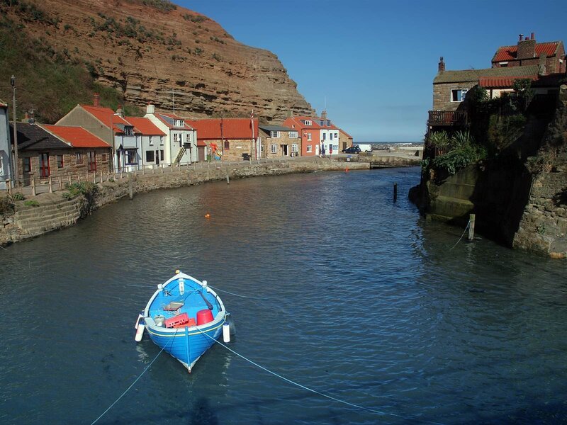 Blue boat in coastal harbor