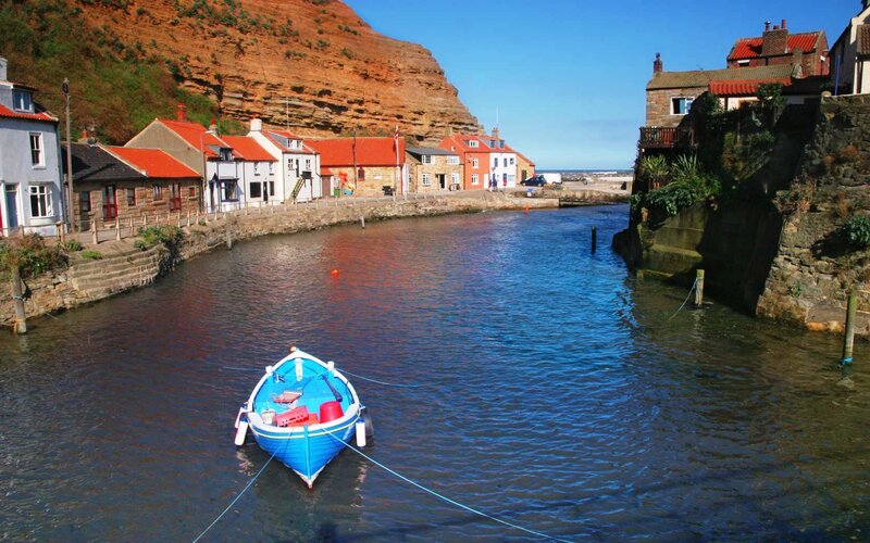 Blue boat in coastal harbor