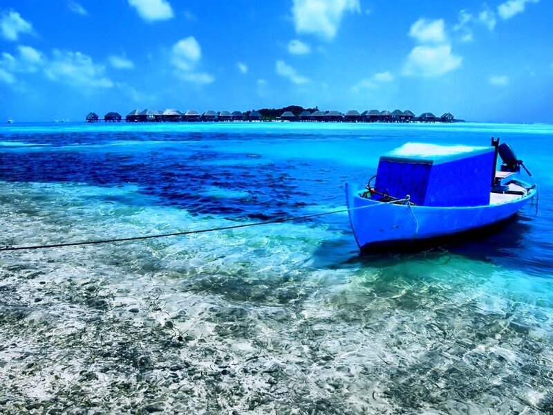 Blue Boat in Turquoise Water — Serene, Afternoon, Photograph
