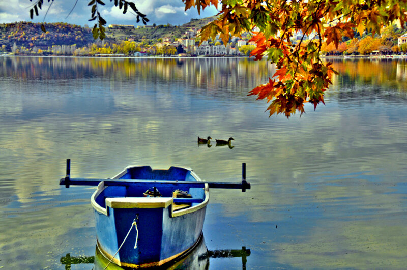 Blue boat on autumn lake