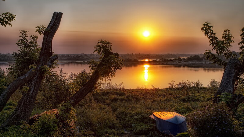 Blue Boat on Riverbank — Orange, Serene