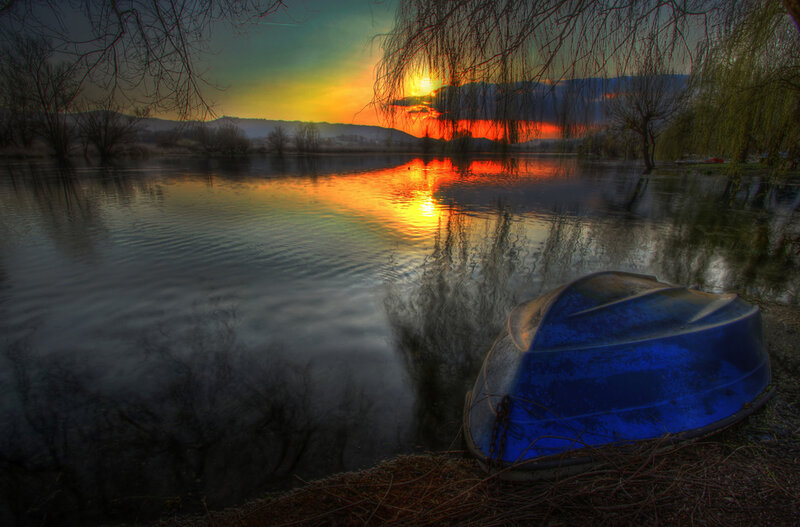 Blue Boat on Riverbank