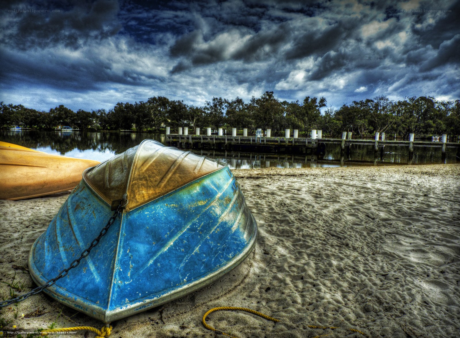 Blue boat on sandy shore
