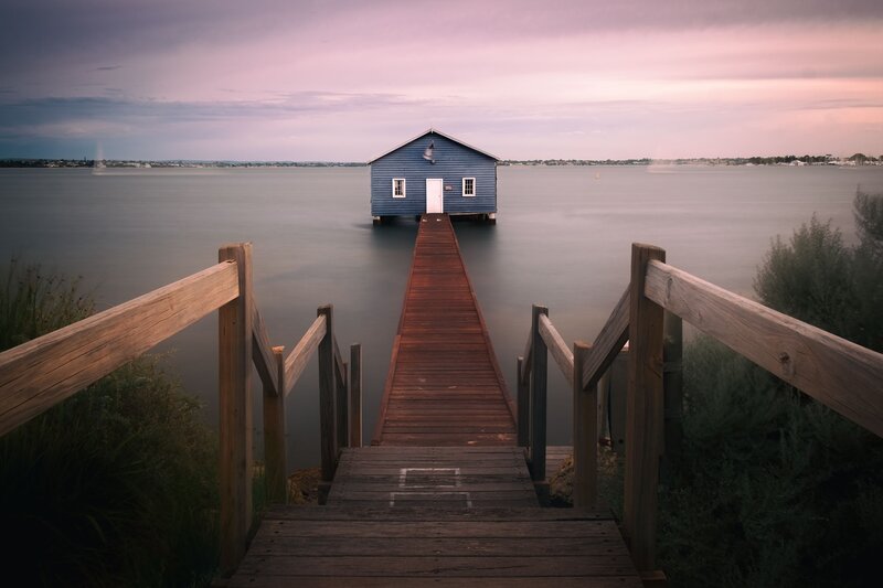 Blue Boathouse on Pier — Serene, Sunset