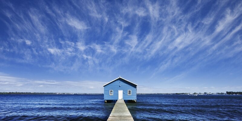Blue Boathouse on Water — Serene